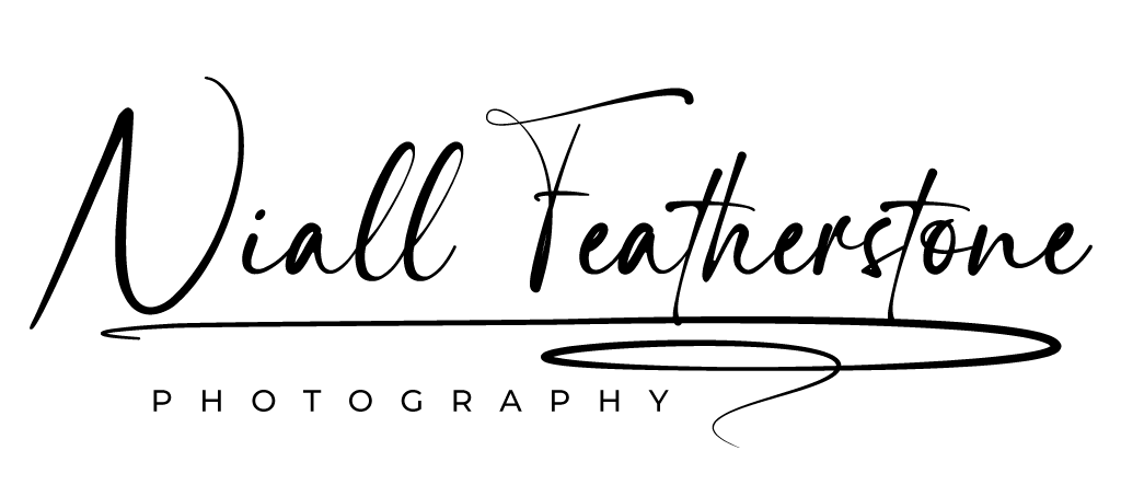 Logo for "Niall Featherstone Photography" in elegant script and capital letters, with decorative flourishes underlining the text.